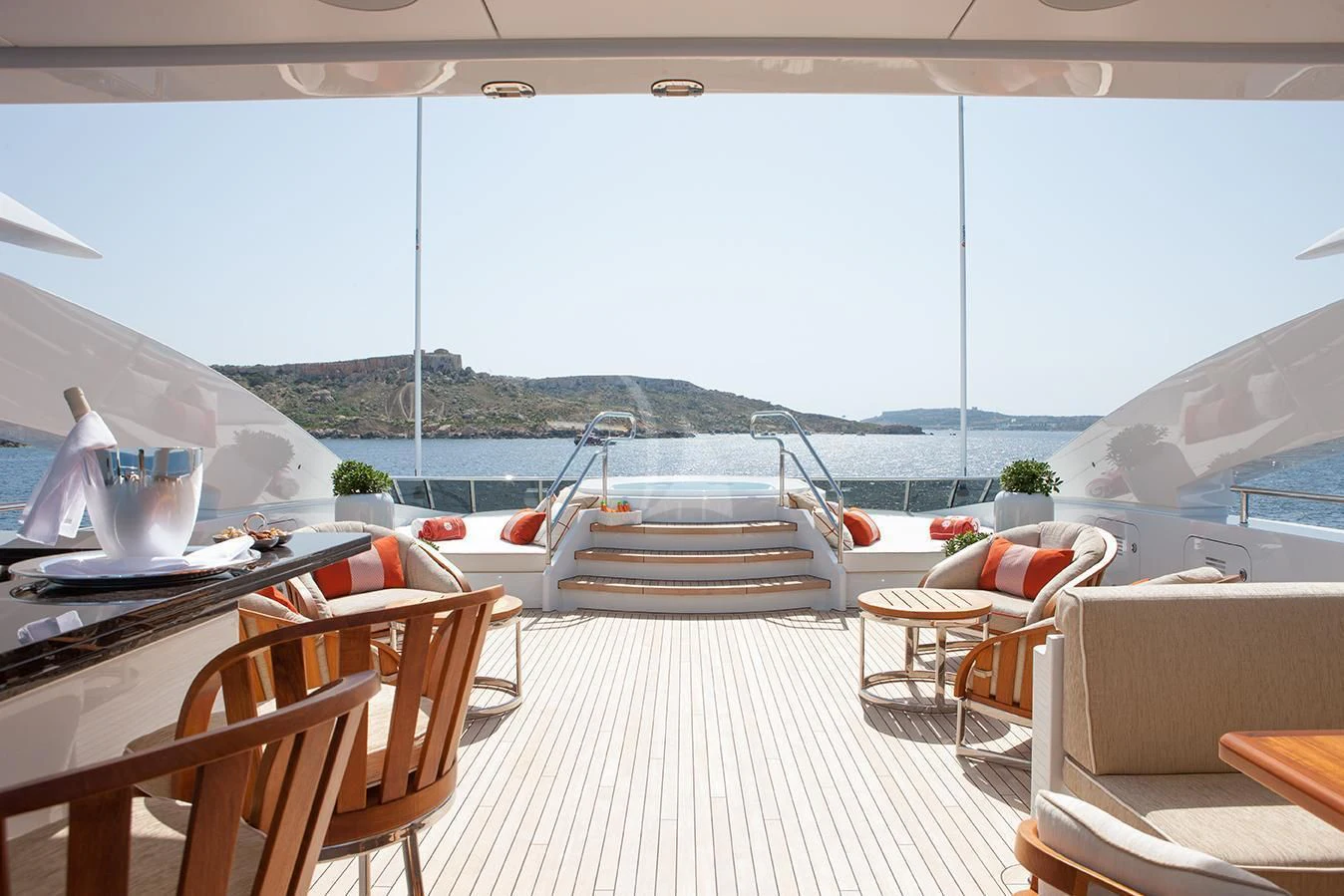 a deck with a table and chairs on it aboard DAISY D Yacht for Sale