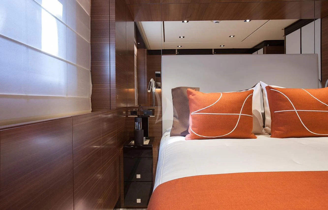 a bed with orange pillows aboard DAISY D Yacht for Sale