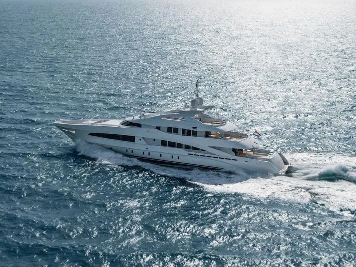 a helicopter flying over a snowy landscape aboard DAISY D Yacht for Sale