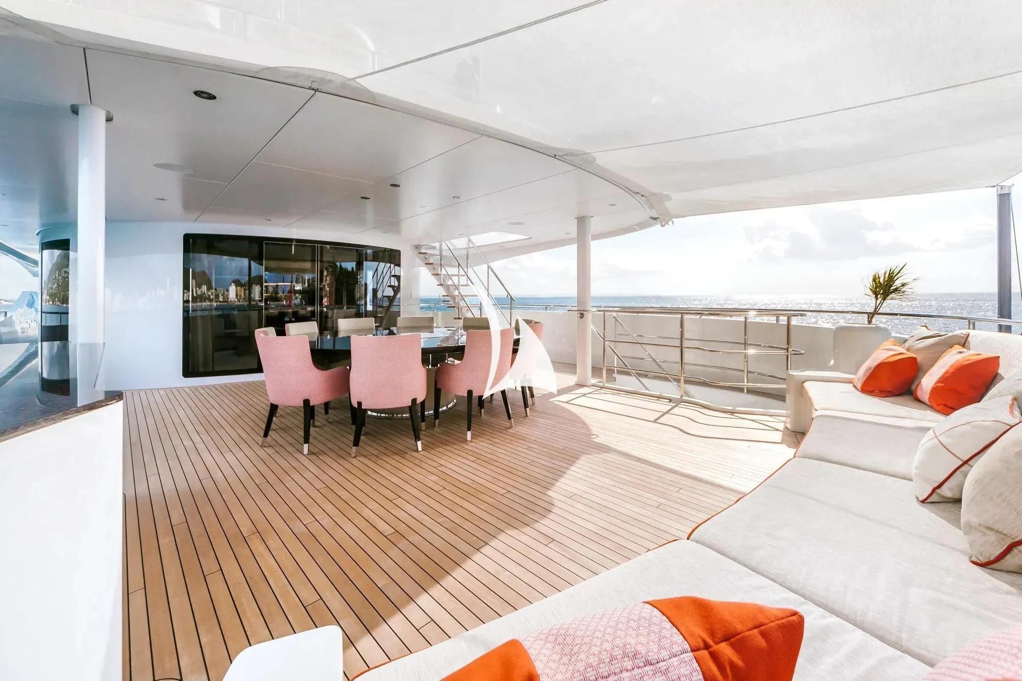 a room with a bed and a table and chairs aboard DAISY D Yacht for Sale