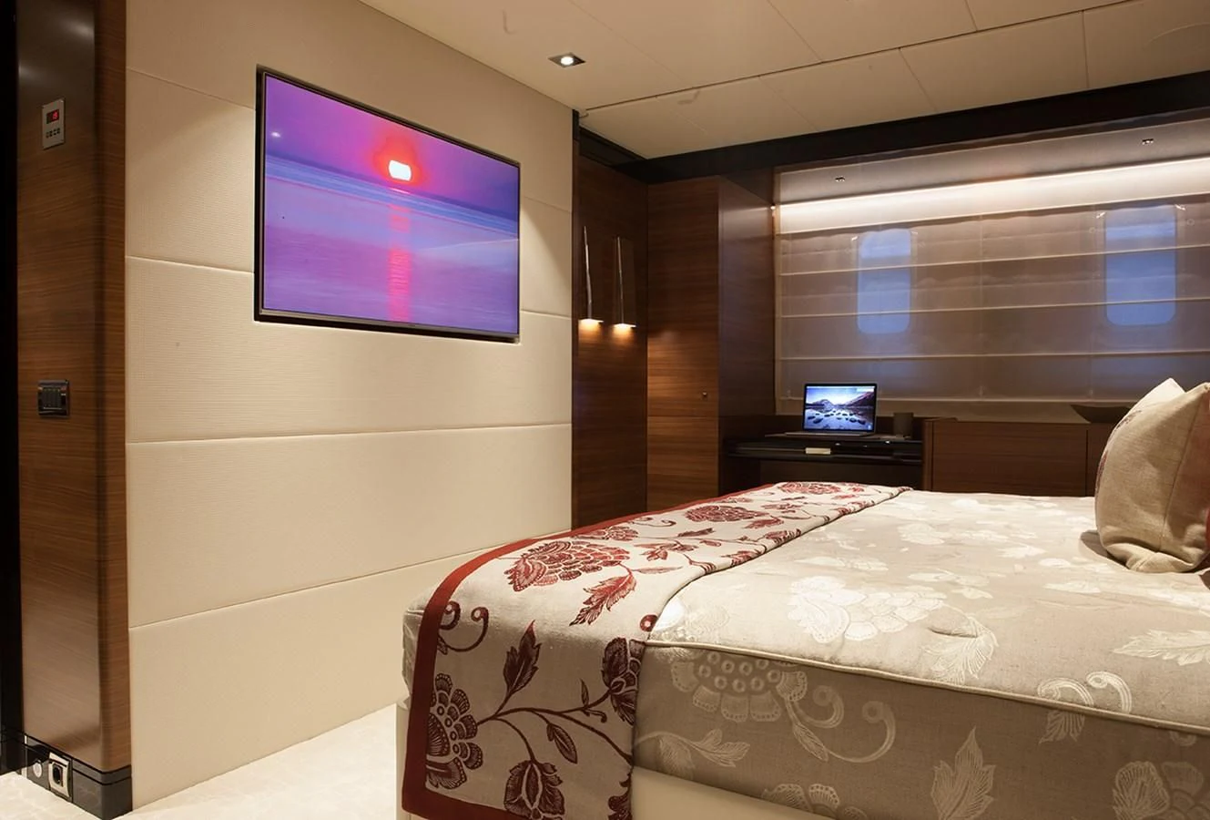 a room with a tv and a bed aboard DAISY D Yacht for Sale