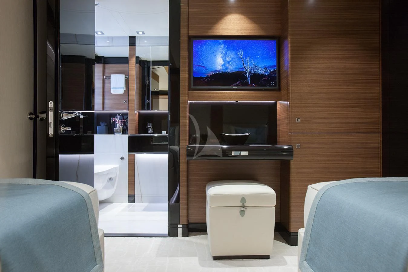 a bathroom with a tv on the wall aboard DAISY D Yacht for Sale