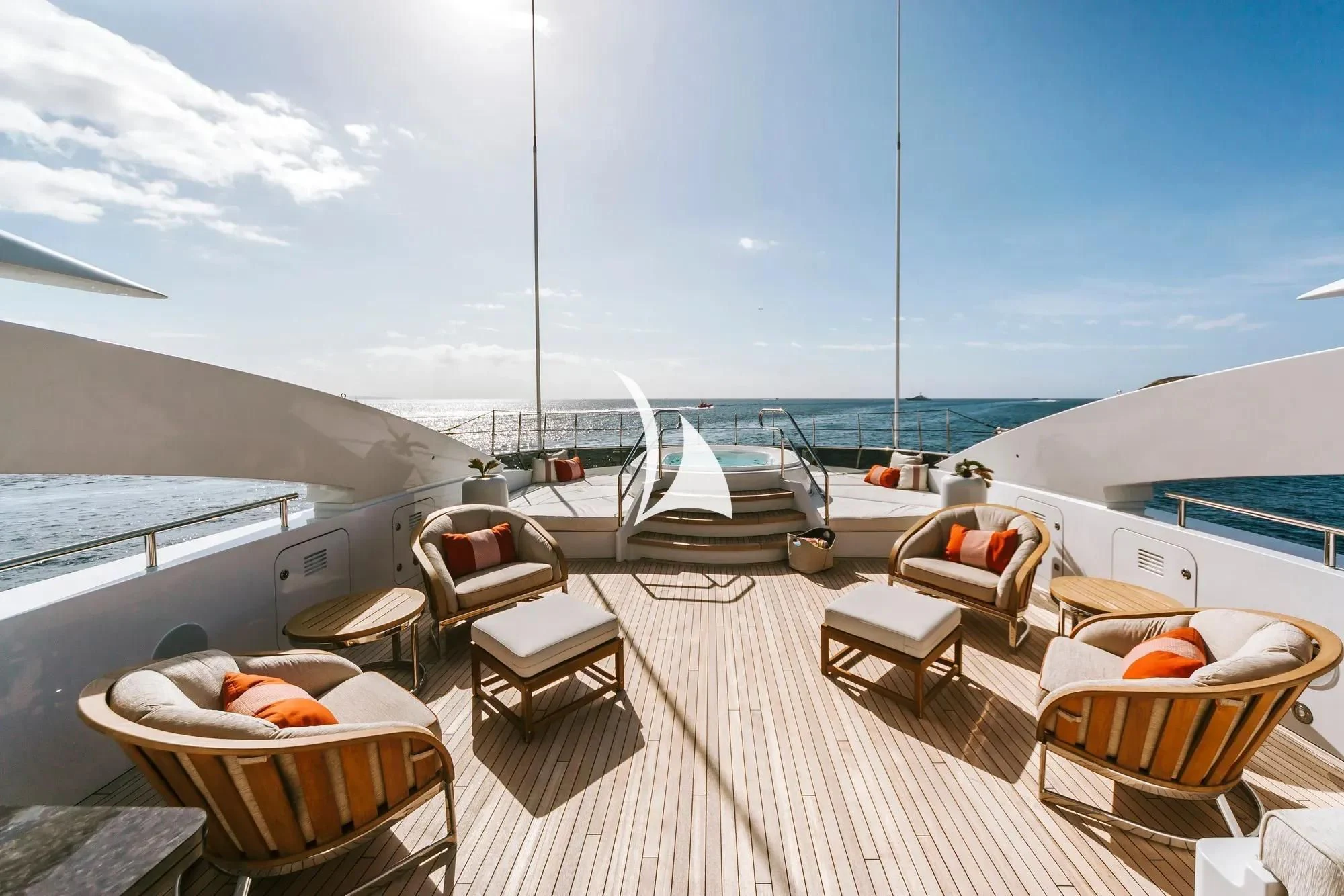 a deck with a view of the ocean and a boat on it aboard DAISY D Yacht for Sale