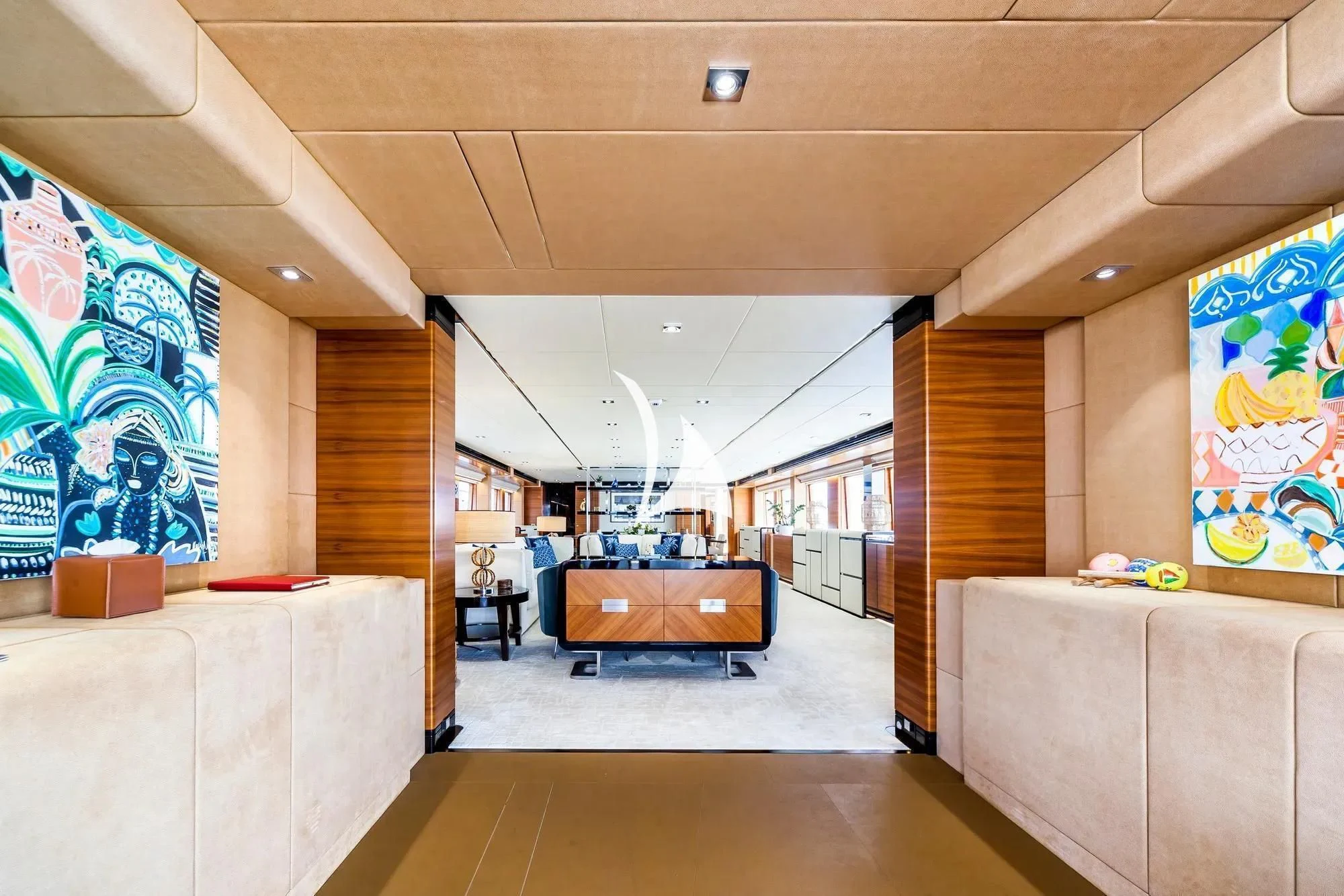 a room with a couch and a large painting on the wall aboard DAISY D Yacht for Sale