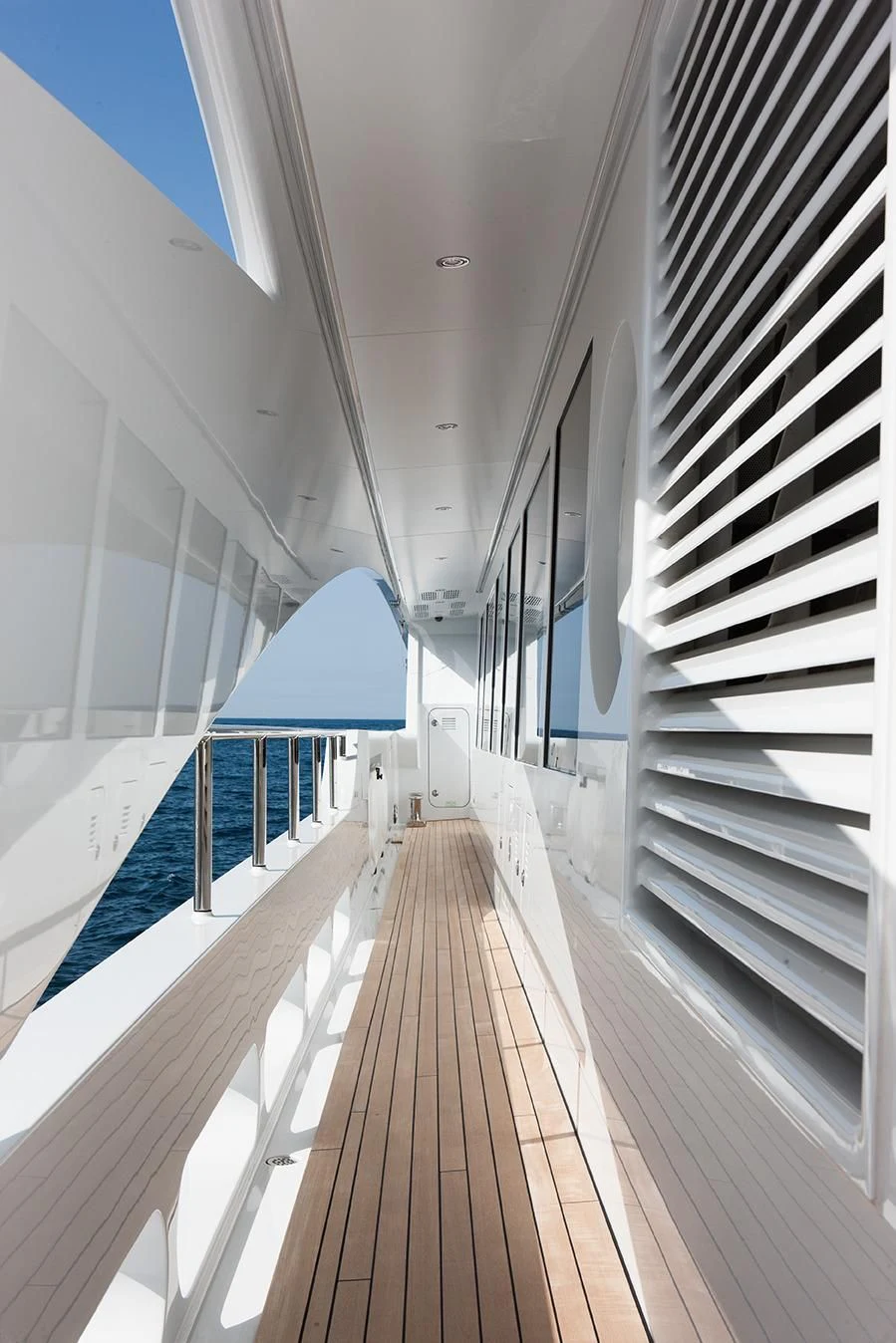 a long hallway with a row of white doors aboard DAISY D Yacht for Sale