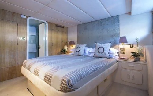 a bedroom with a bed and a desk aboard ATLANTIC ENDEAVOUR Yacht for Charter