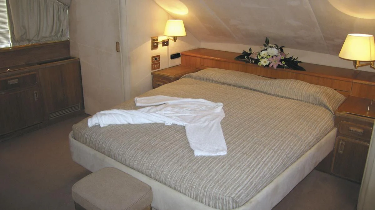 a bed with white sheets aboard ATLANTIC ENDEAVOUR Yacht for Charter