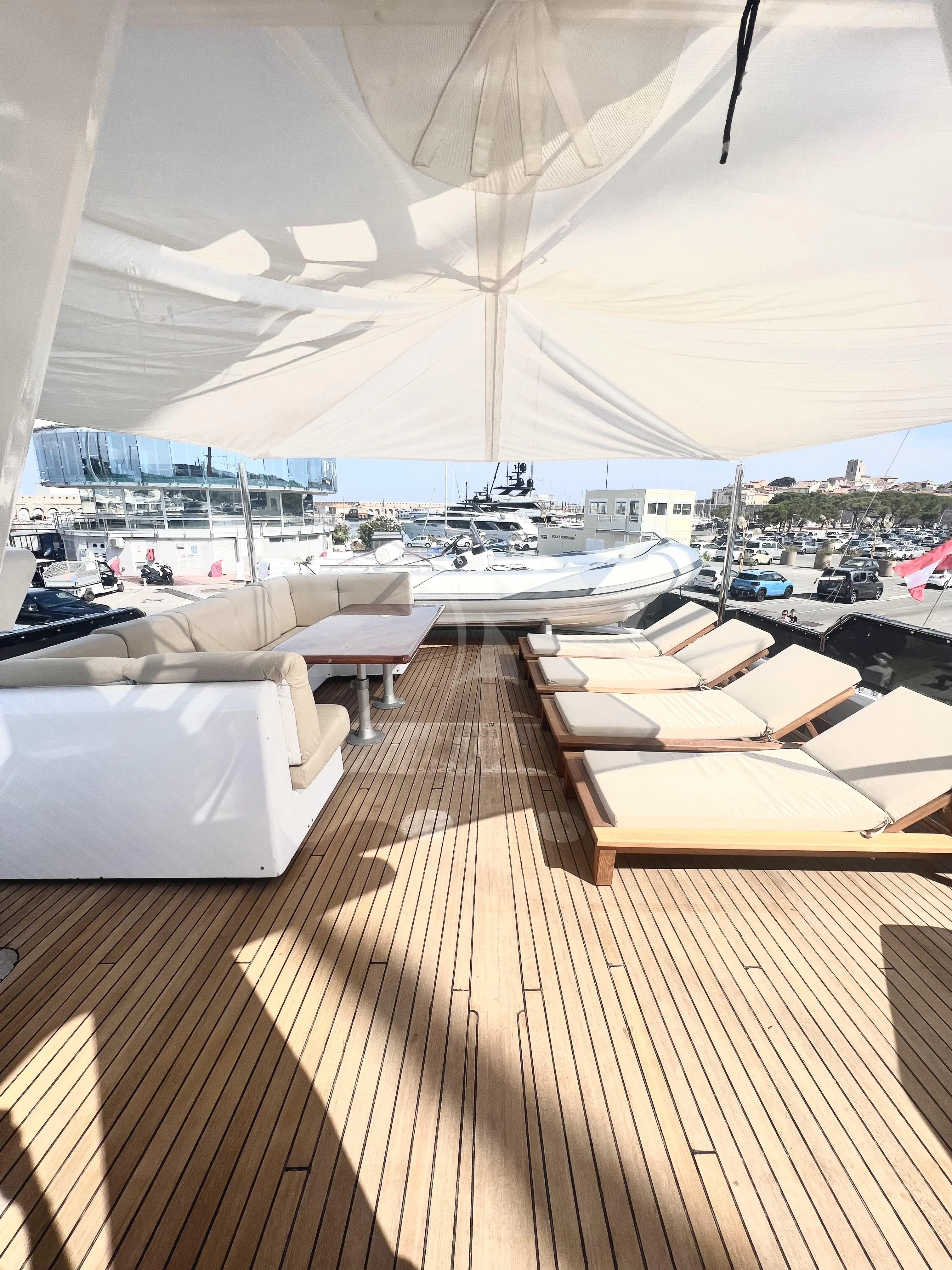 a room with a deck and a view of a city aboard ATLANTIC ENDEAVOUR Yacht for Charter