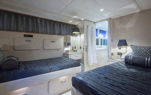 a bedroom with a bed and a desk aboard ATLANTIC ENDEAVOUR Yacht for Charter