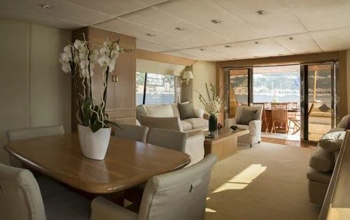 a living room with a vase of flowers on a table aboard ATLANTIC ENDEAVOUR Yacht for Charter