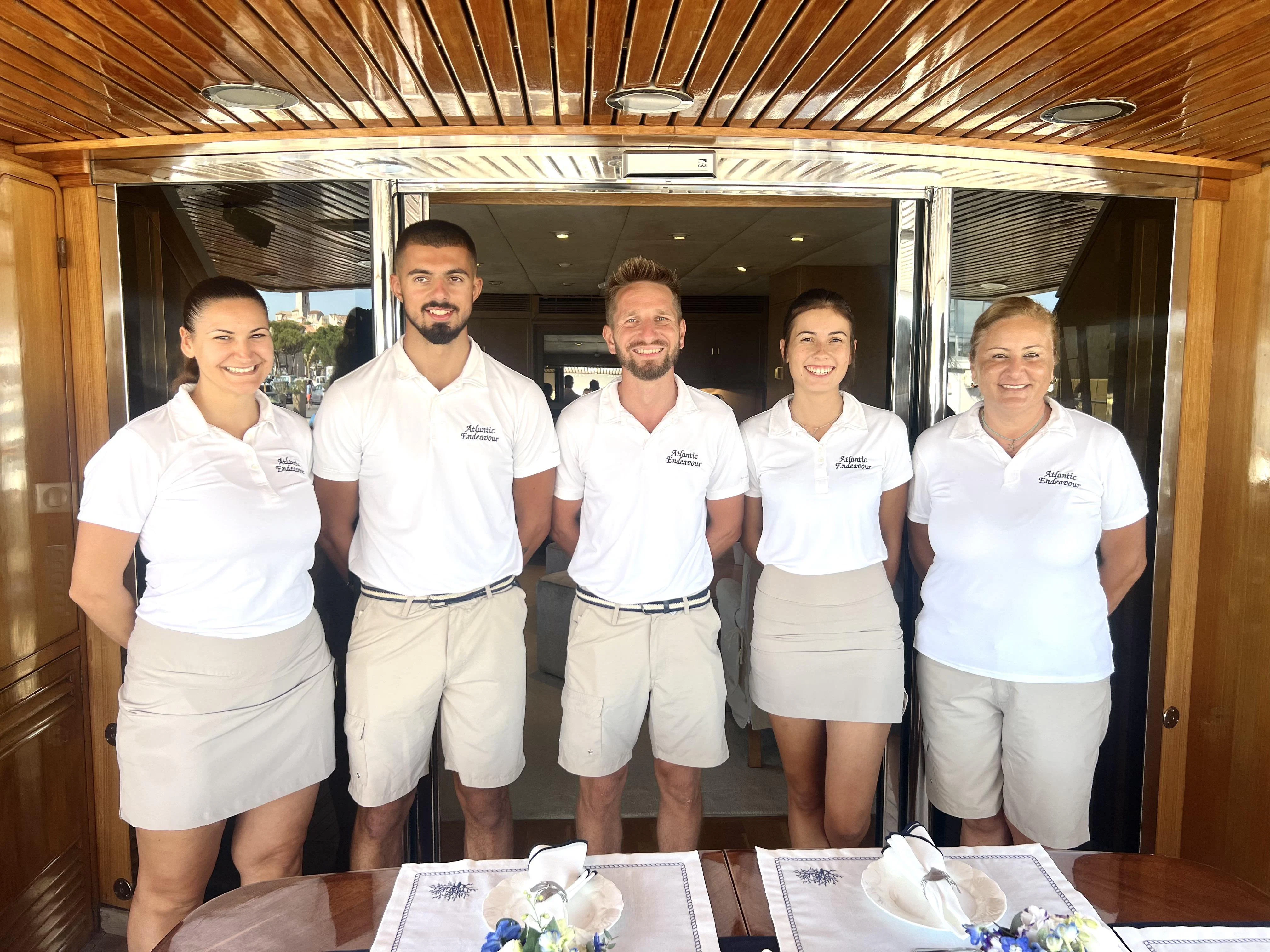 a group of people posing for a photo aboard ATLANTIC ENDEAVOUR Yacht for Charter