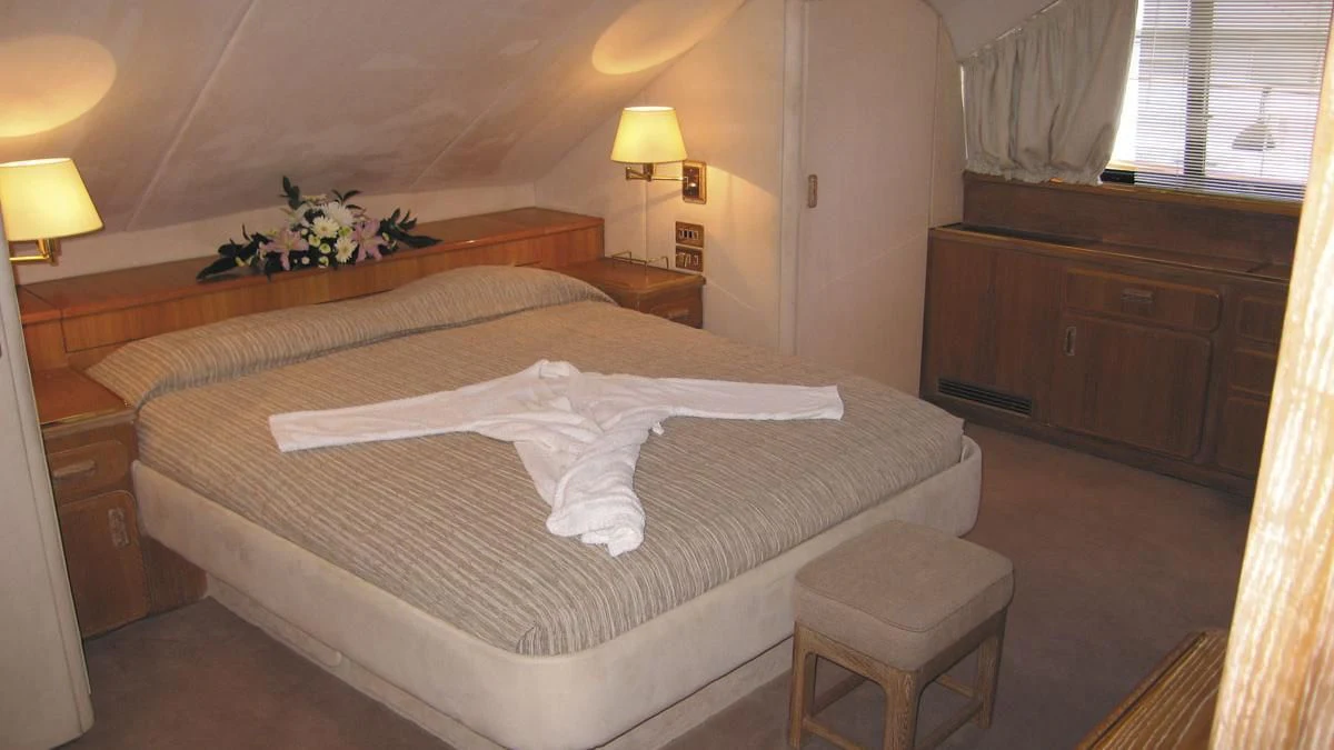 a hotel room with a large bed aboard ATLANTIC ENDEAVOUR Yacht for Charter