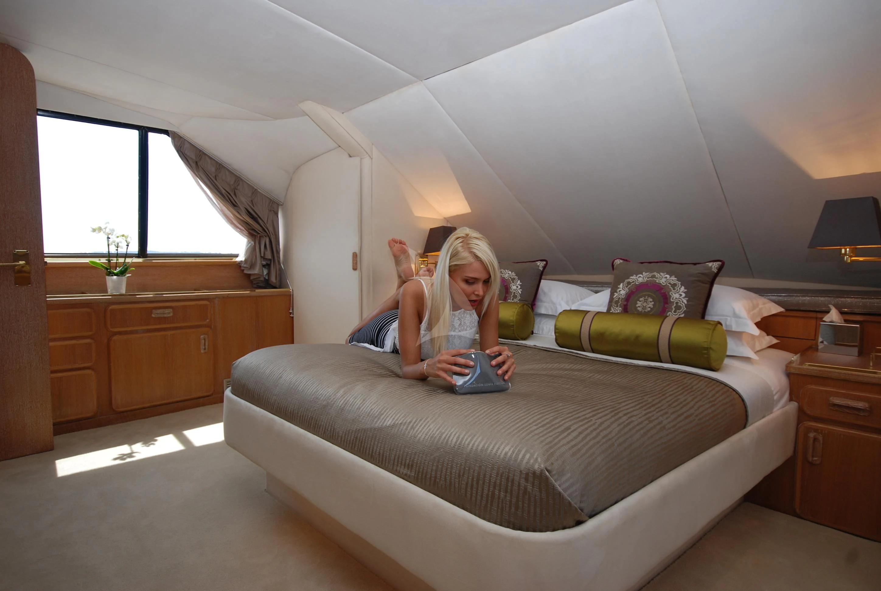a person sitting on a bed aboard ATLANTIC ENDEAVOUR Yacht for Charter