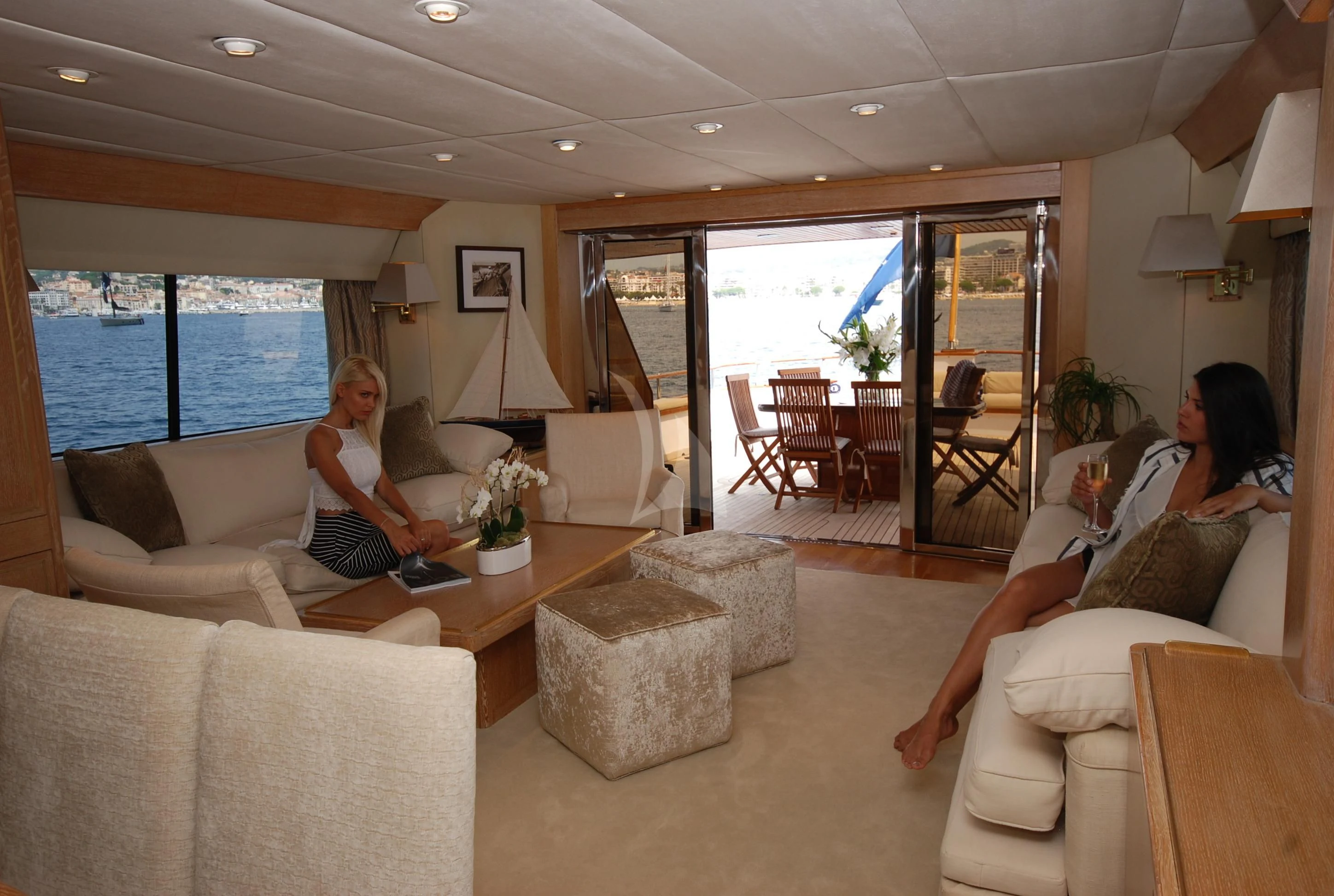 a couple of women sitting on a couch in a living room aboard ATLANTIC ENDEAVOUR Yacht for Charter