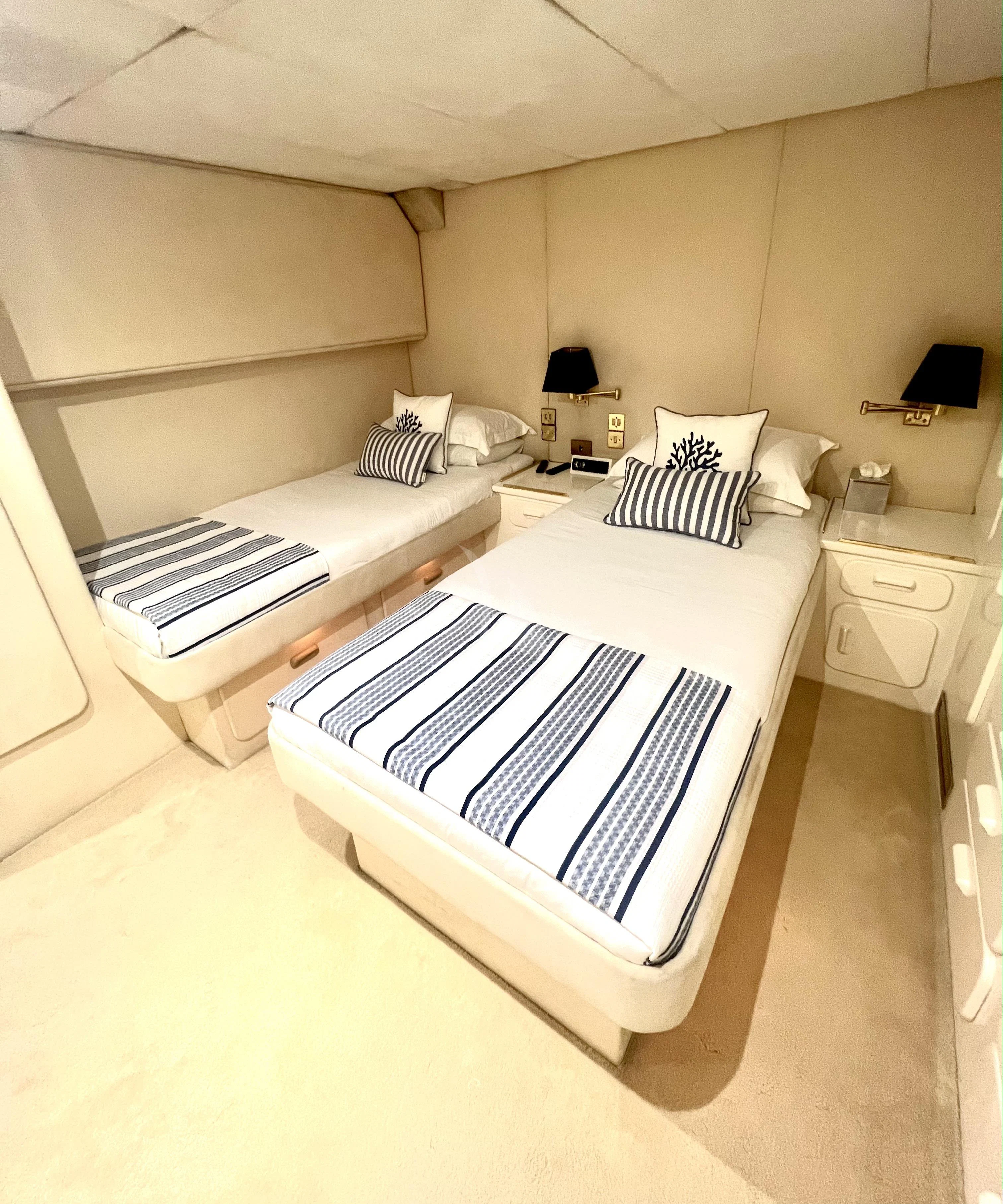 a room with a bed and a desk aboard ATLANTIC ENDEAVOUR Yacht for Charter
