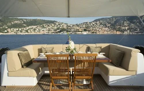a table and chairs on a balcony aboard ATLANTIC ENDEAVOUR Yacht for Charter
