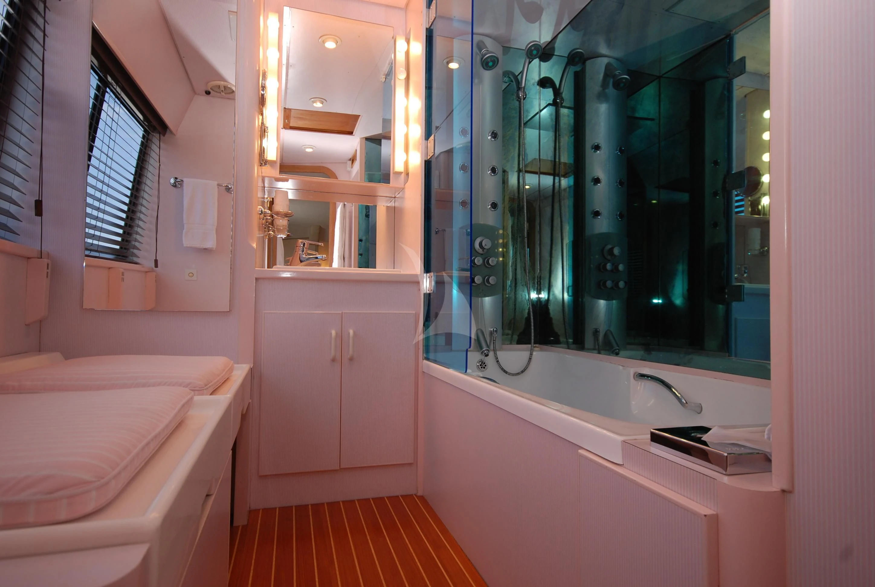 a bathroom with a tub sink and a mirror aboard ATLANTIC ENDEAVOUR Yacht for Charter