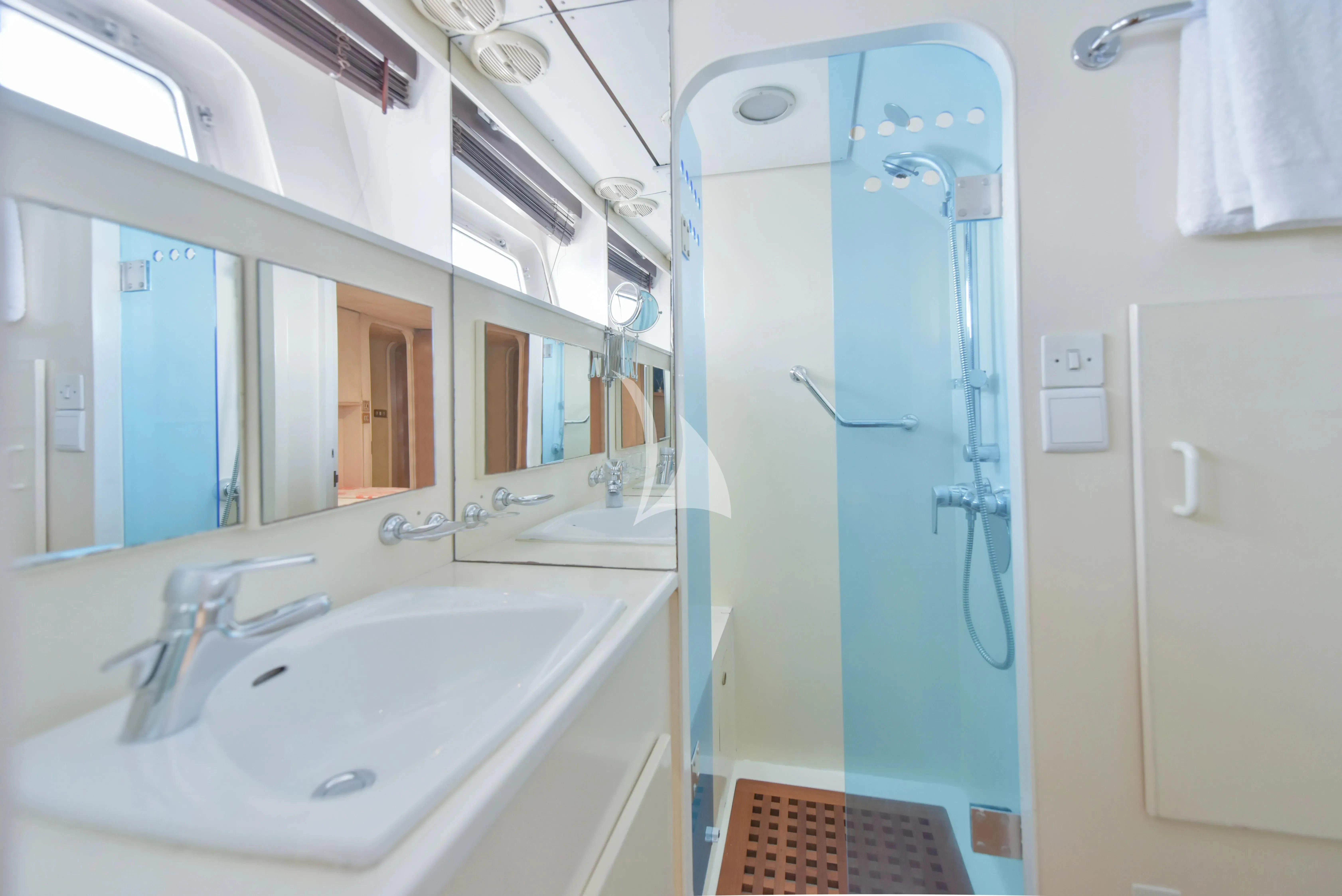 a bathroom with a blue shower door aboard ATLANTIC ENDEAVOUR Yacht for Charter
