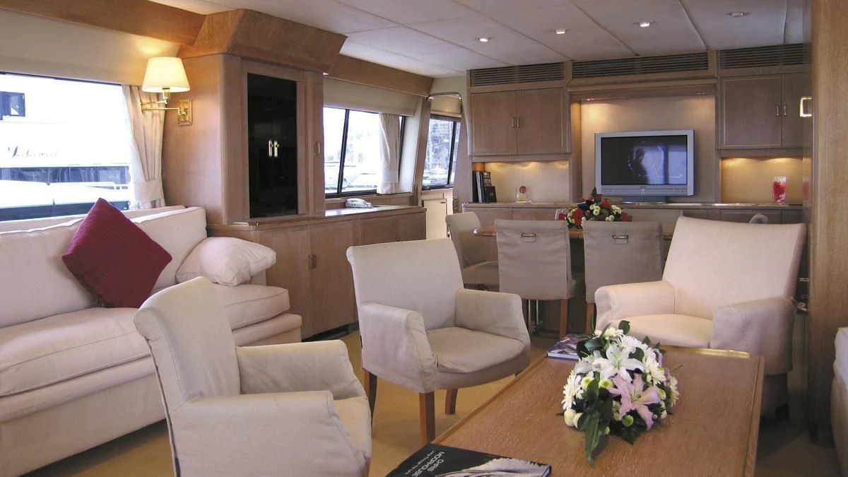 a living room with white furniture aboard ATLANTIC ENDEAVOUR Yacht for Charter