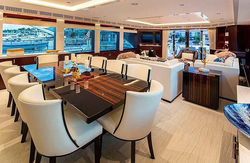 a room with tables and chairs aboard LION'S DEN Yacht for Sale