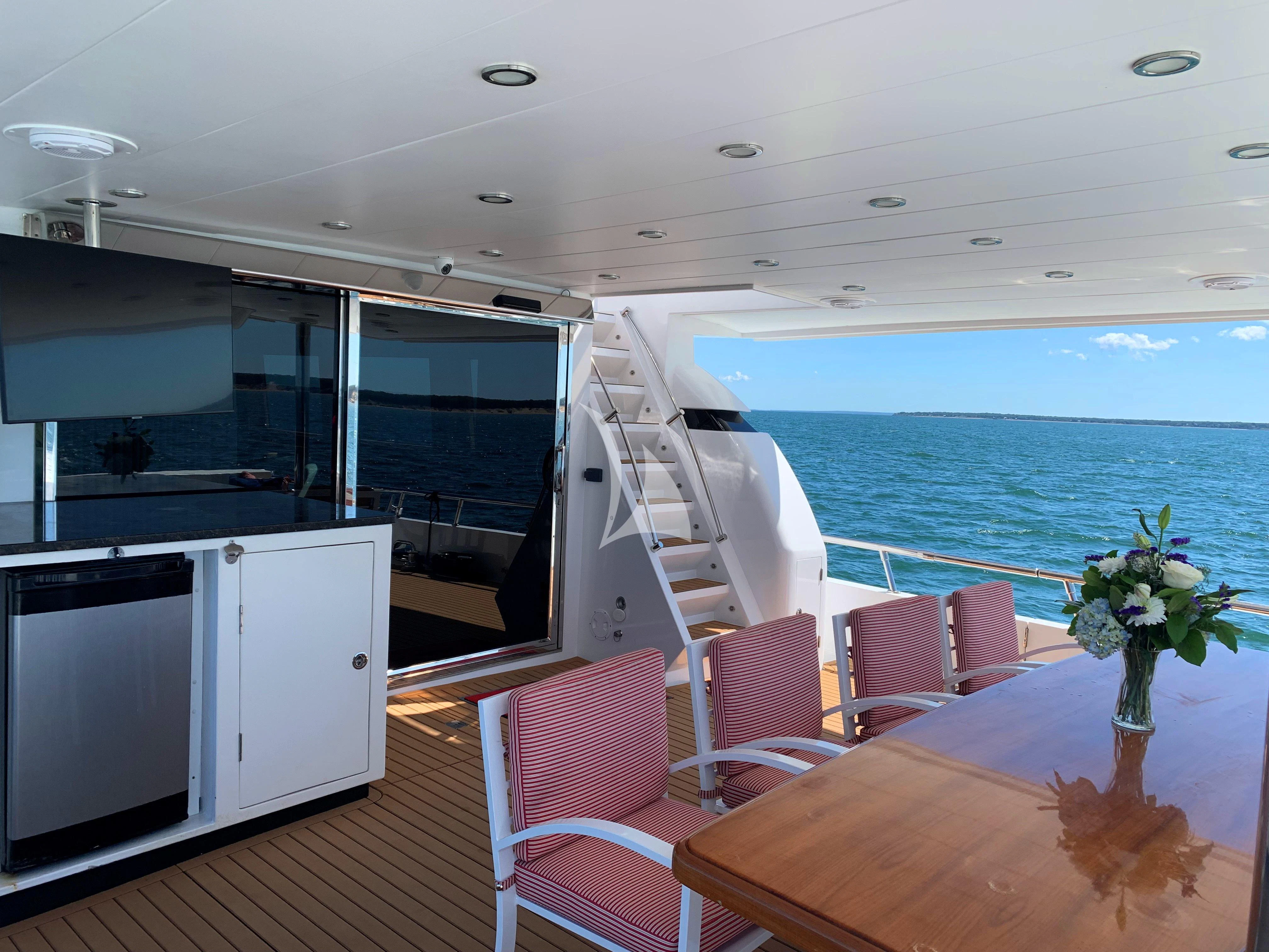 a large open space with a balcony aboard SLIPAWAY Yacht for Sale