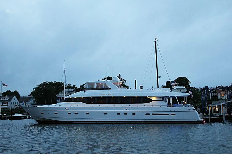 a large white boat in a harbor aboard SLIPAWAY Yacht for Sale