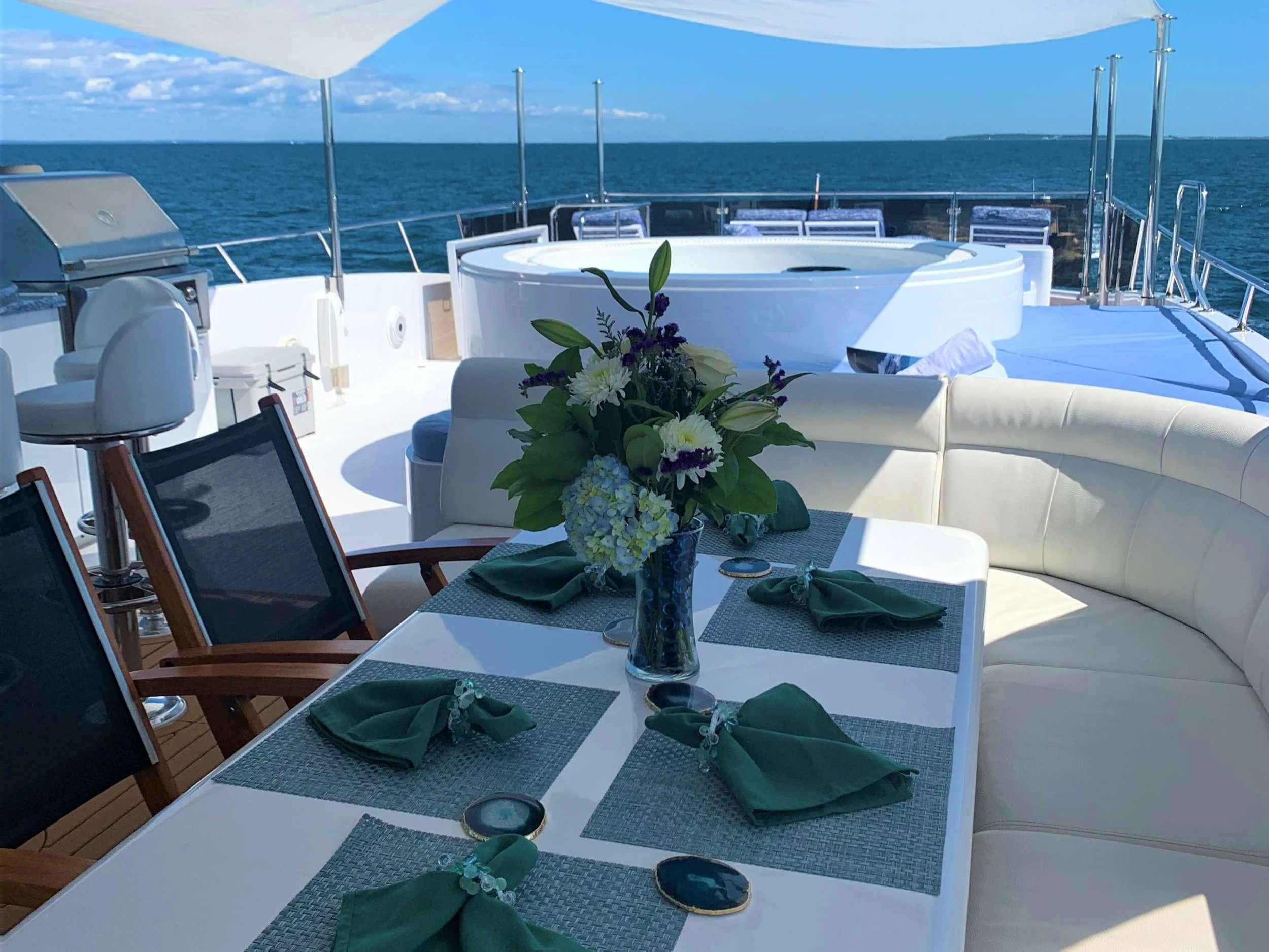 a table with a laptop and flowers on it aboard SLIPAWAY Yacht for Sale