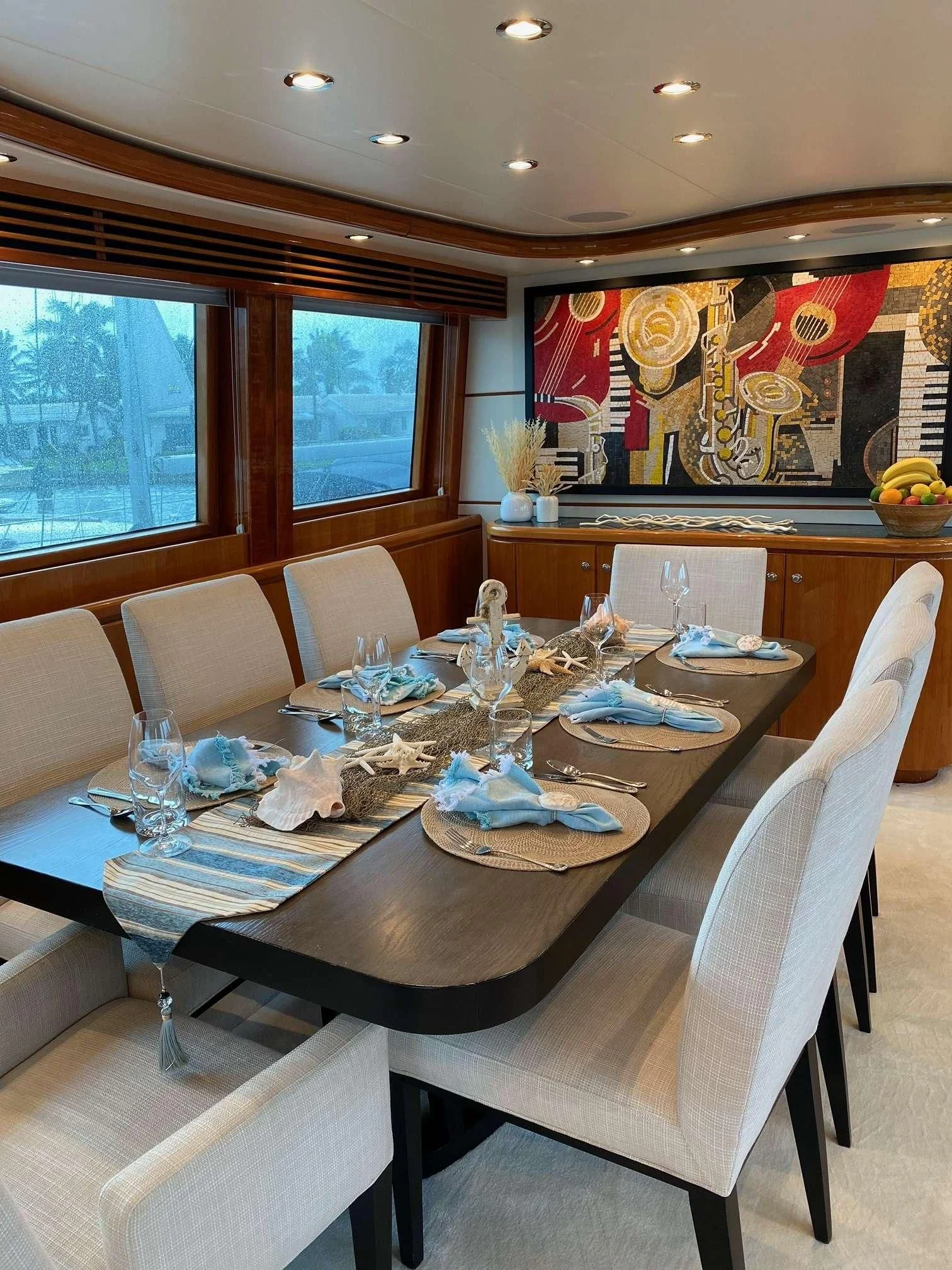 a dining table with a set of chairs and a large window aboard SLIPAWAY Yacht for Sale