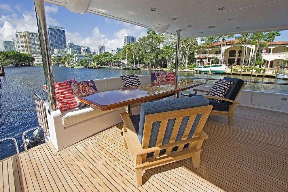 a deck with a table and chairs on it aboard SLIPAWAY Yacht for Sale