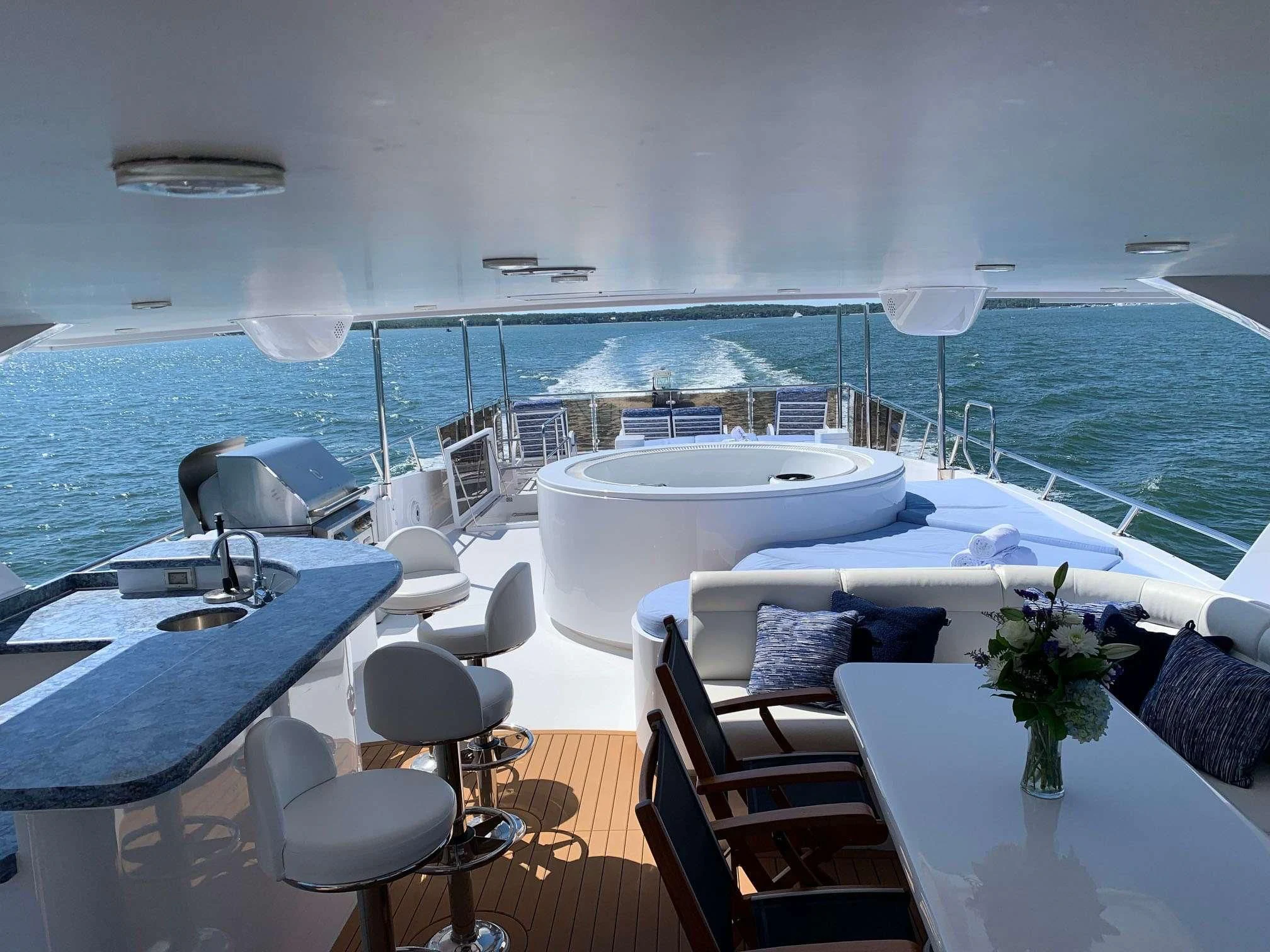 a room with a table chairs and a large body of water aboard SLIPAWAY Yacht for Sale