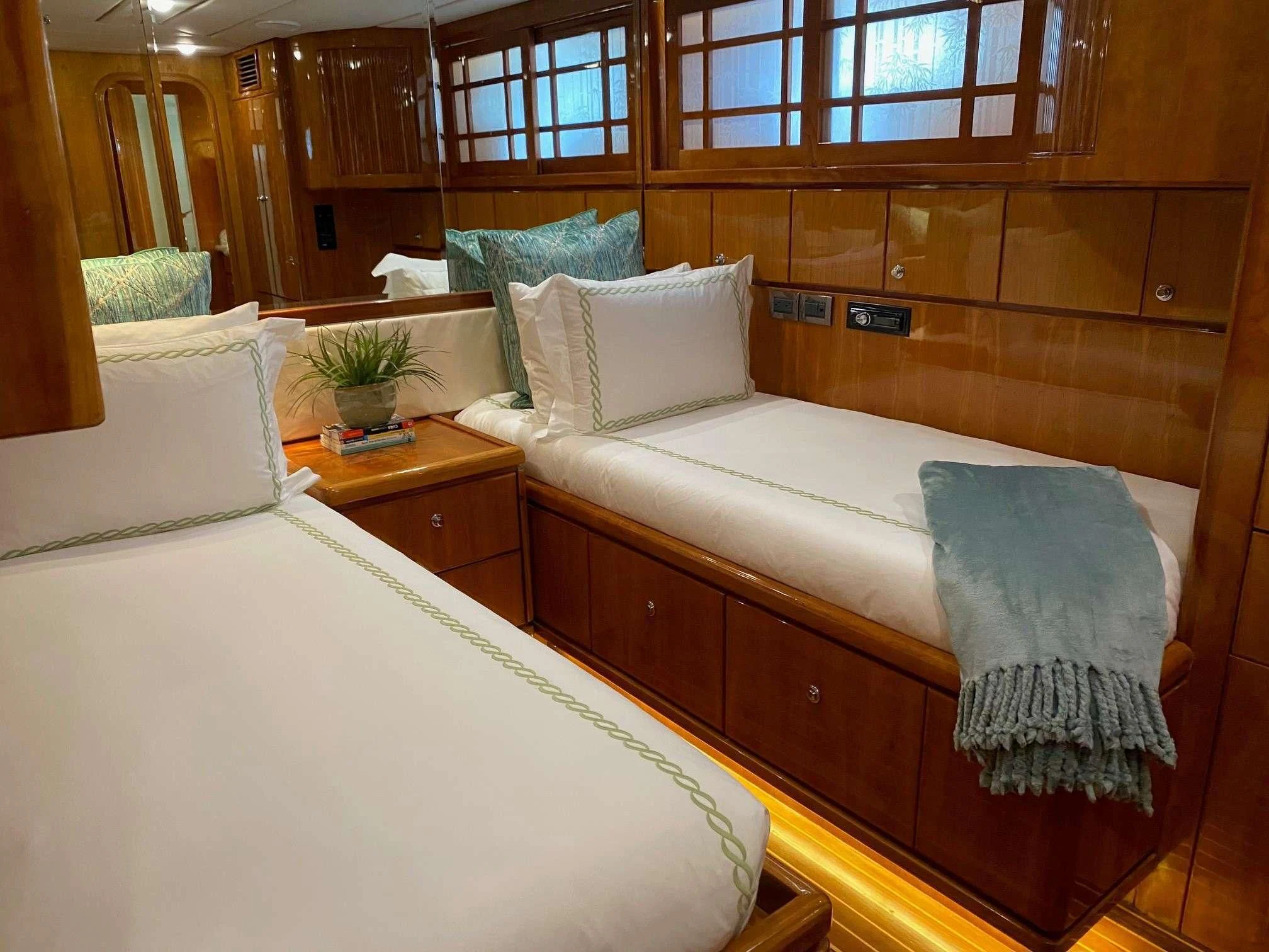 a bed with a white bed aboard SLIPAWAY Yacht for Sale