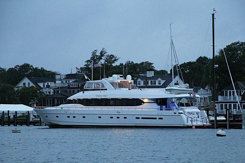 a large white boat in a harbor aboard SLIPAWAY Yacht for Sale