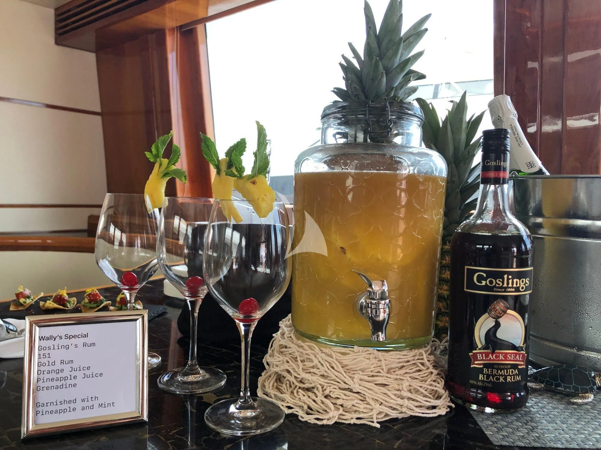 a table with glasses and bottles of wine aboard SLIPAWAY Yacht for Sale