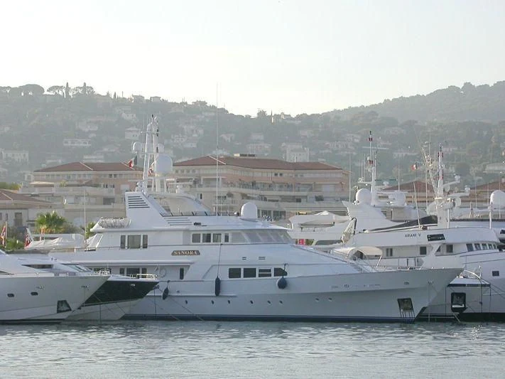 a couple of large white boats in a harbor aboard SANORA Yacht for Sale