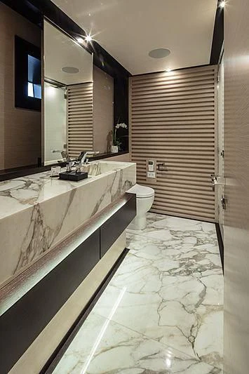 a bathroom with a tub sink and toilet aboard AGORA III Yacht for Sale