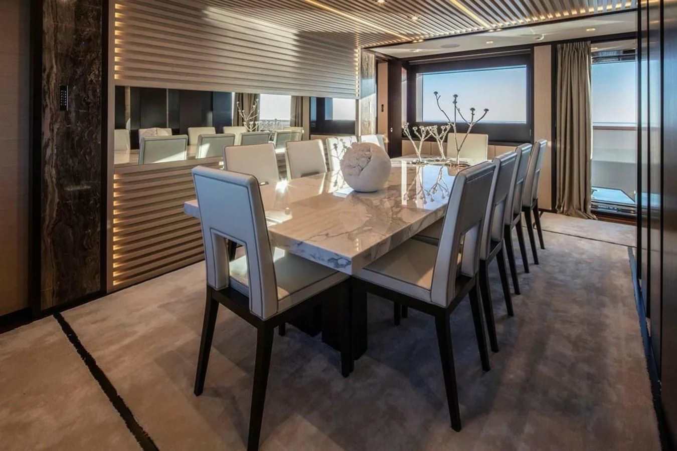a dining table in a room aboard AGORA III Yacht for Sale