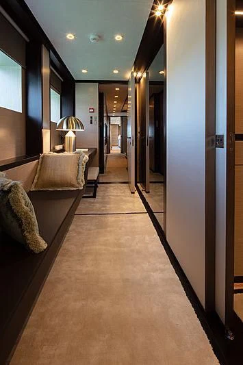 a hallway with couches and a lamp aboard AGORA III Yacht for Sale
