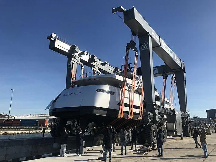 a group of people standing next to a large metal structure aboard AGORA III Yacht for Sale