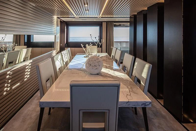 a dining table in a room aboard AGORA III Yacht for Sale