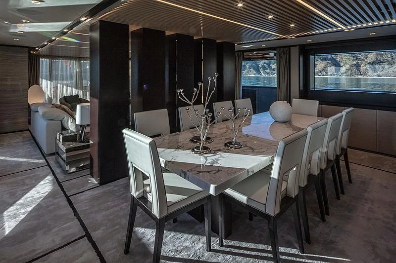a room with a table and chairs aboard AGORA III Yacht for Sale