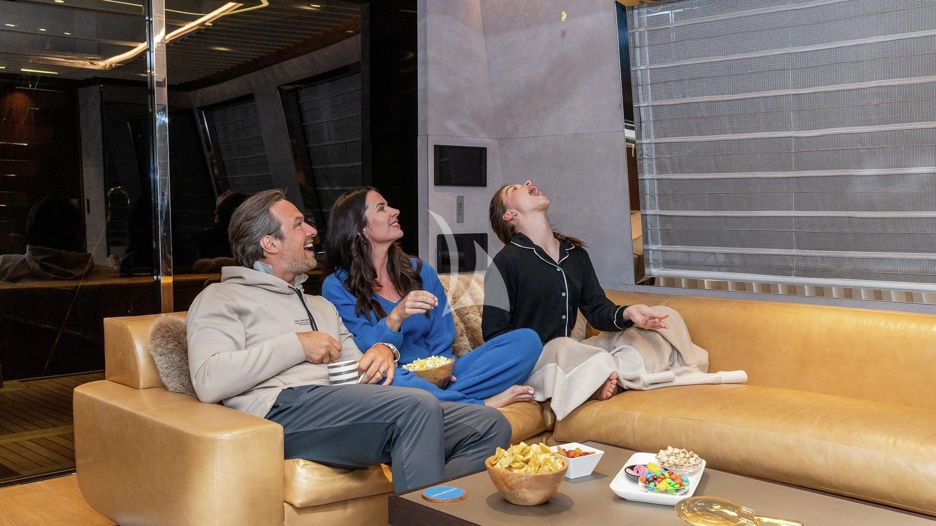 a group of people sitting on a couch aboard ENTERPRISE Yacht for Charter