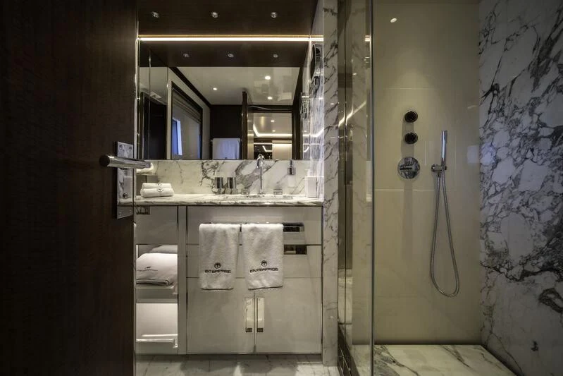 a bathroom with a mirror and a sink aboard ENTERPRISE Yacht for Charter
