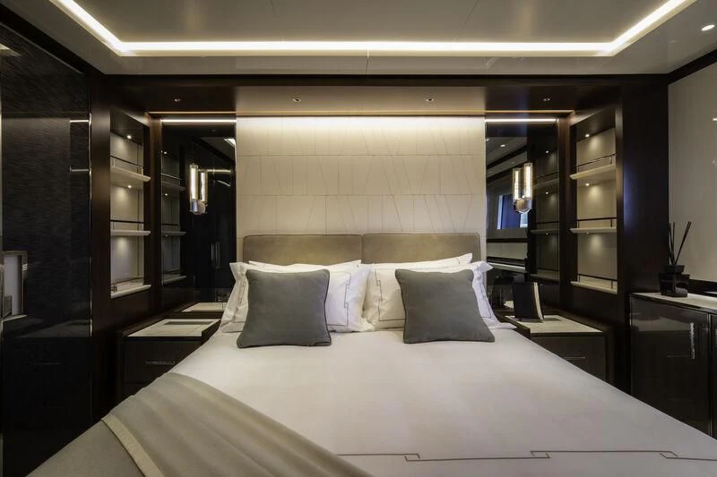 a bed with white sheets aboard ENTERPRISE Yacht for Charter
