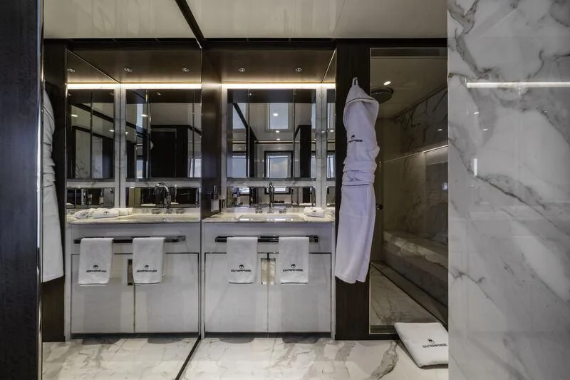 a person standing in a kitchen aboard ENTERPRISE Yacht for Charter
