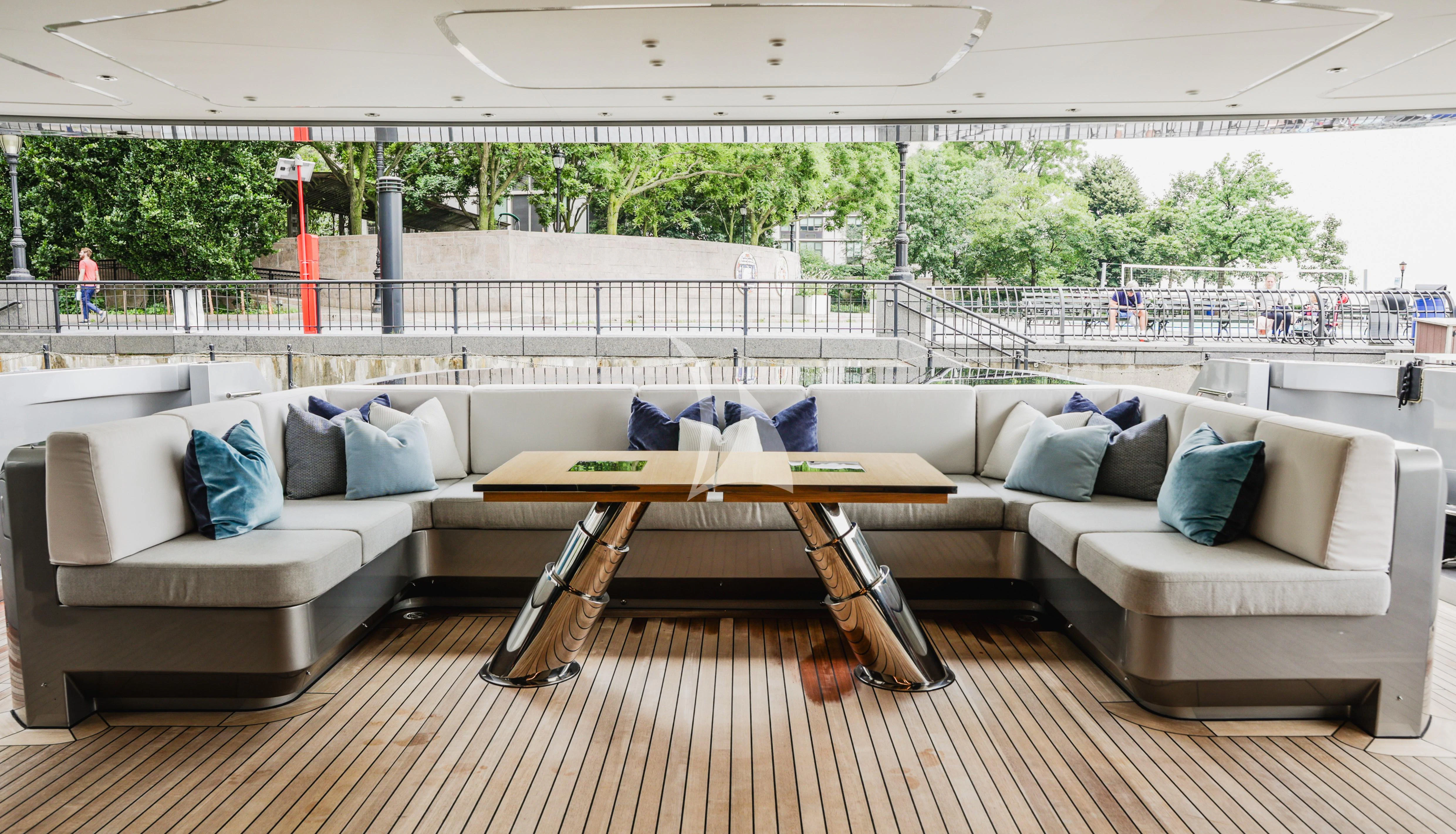a couch and a table in a room with a railing and a railing aboard ENTERPRISE Yacht for Charter