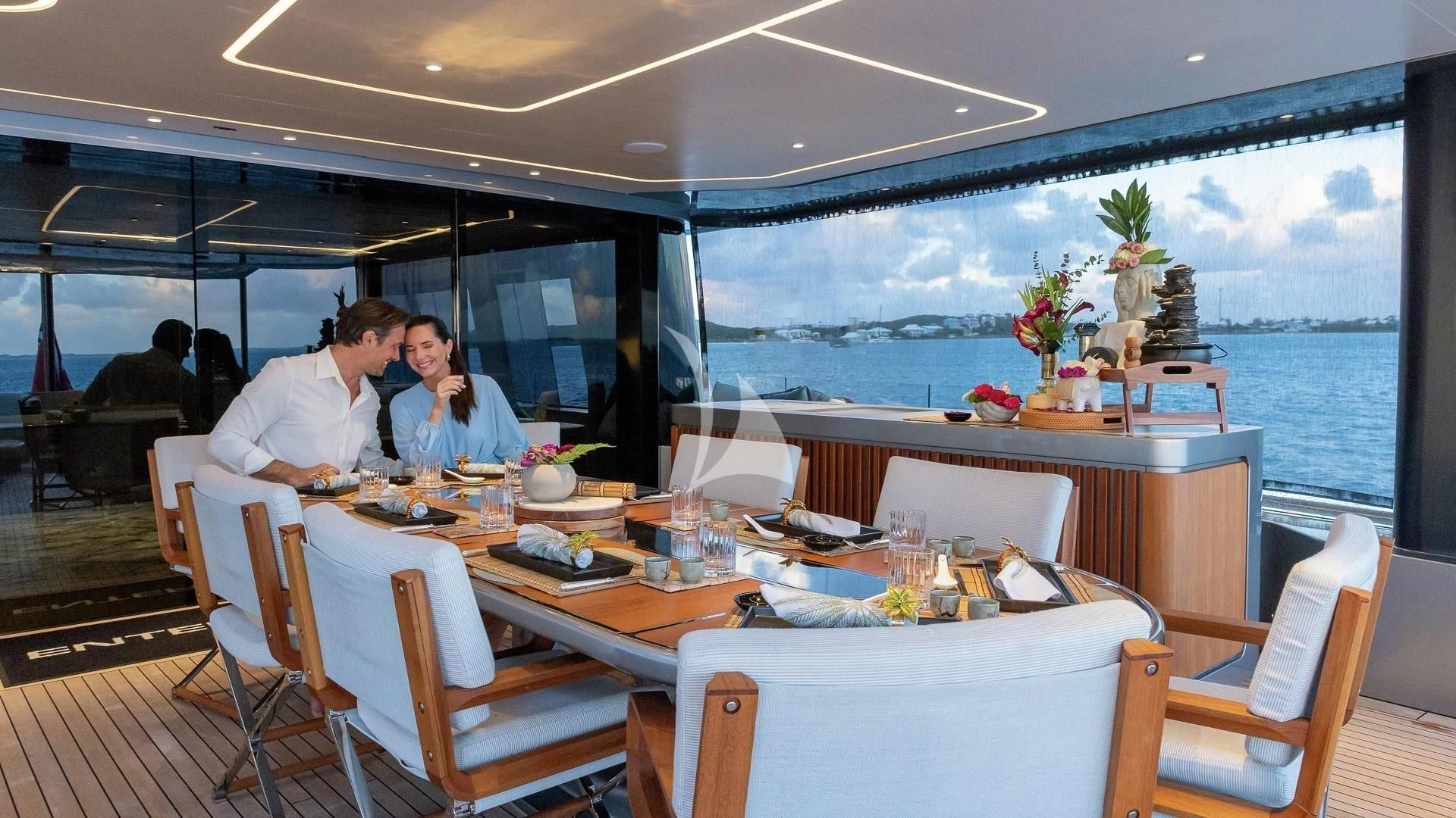 a group of people sitting around a table aboard ENTERPRISE Yacht for Charter