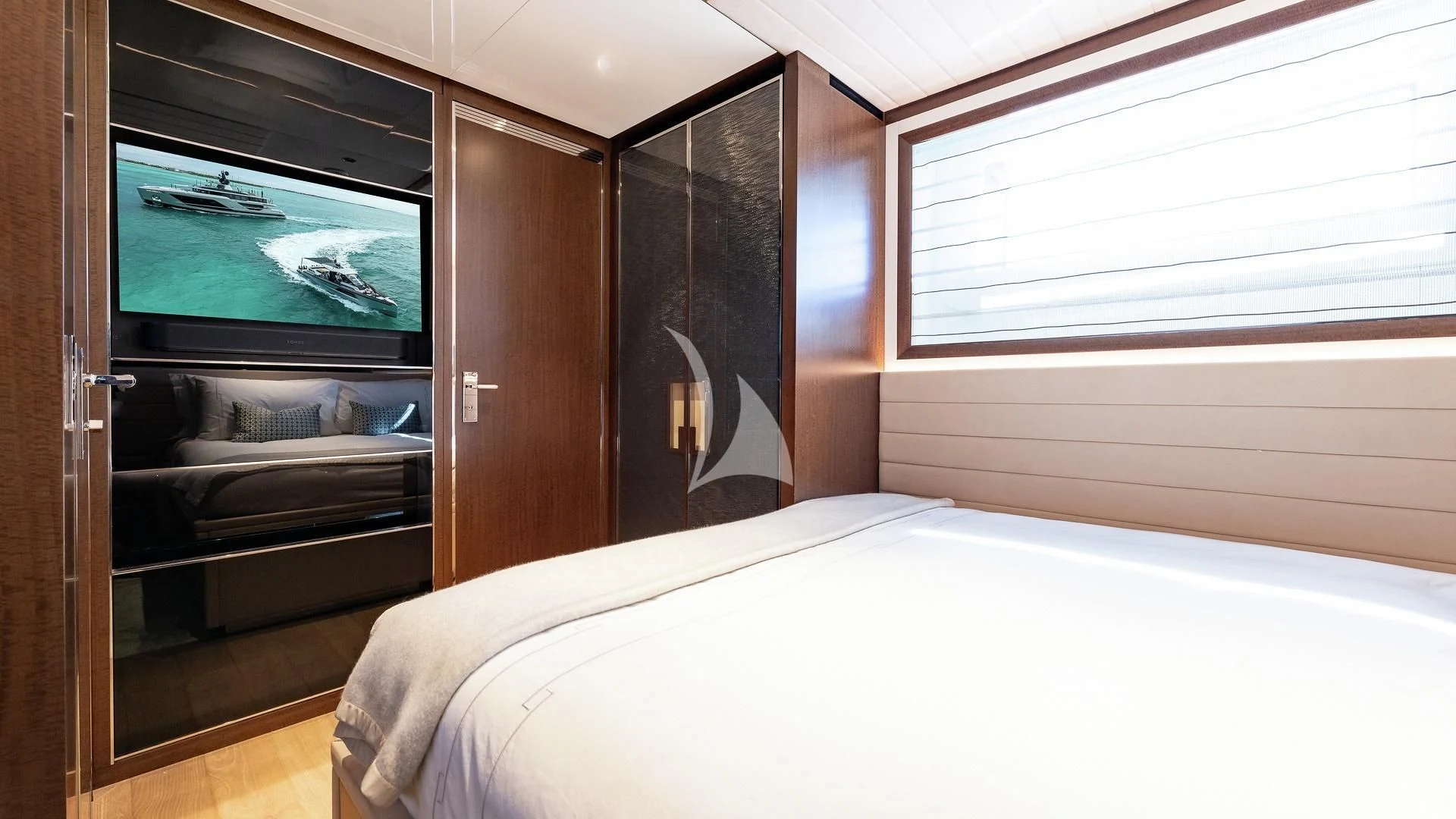 a bedroom with a bed and a television aboard ENTERPRISE Yacht for Charter