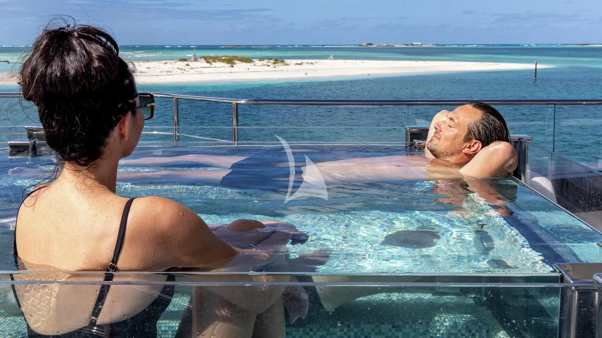 a man and a woman in a pool aboard ENTERPRISE Yacht for Charter