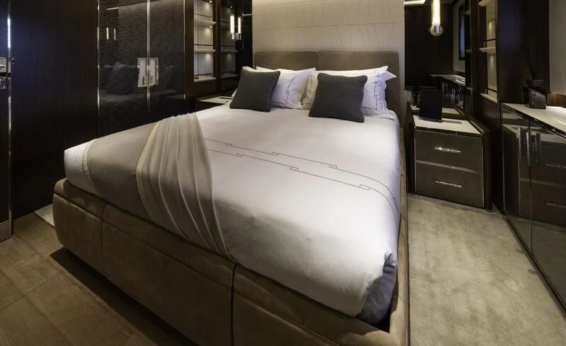 a bed with white sheets aboard ENTERPRISE Yacht for Charter