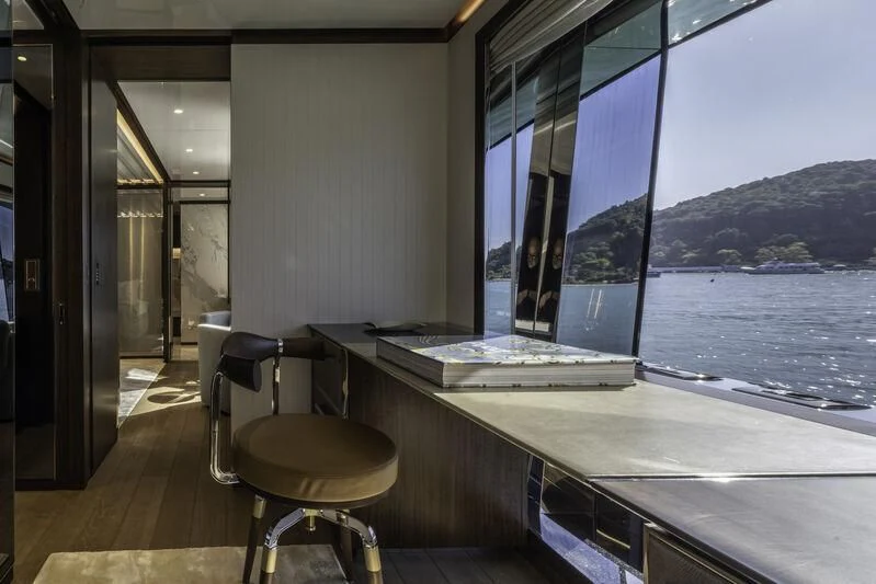 a room with a table and stools and a window aboard ENTERPRISE Yacht for Charter